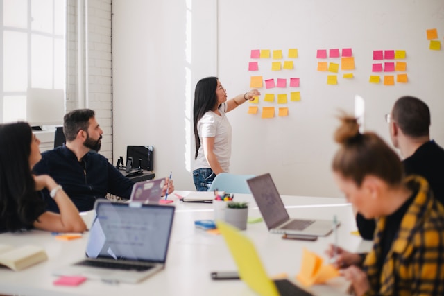 woman-placing-sticky-notes-on-wall